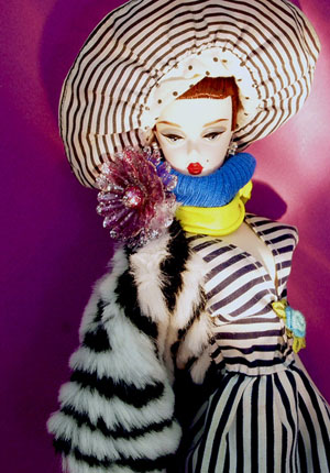 Barbie doll wearing a dress with stripes